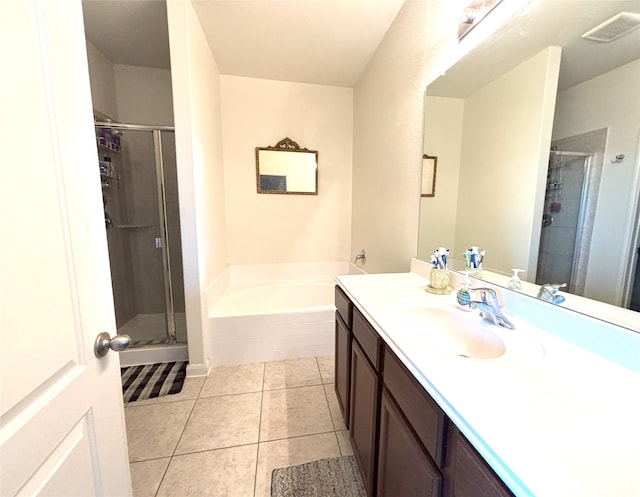 bathroom with vanity, tile patterned floors, and plus walk in shower