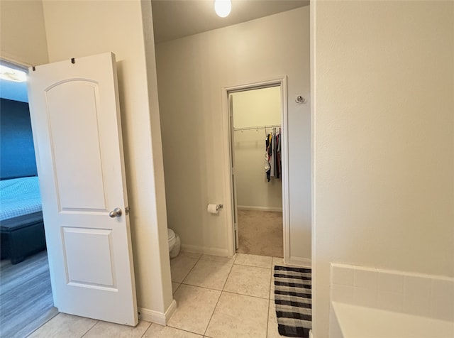 bathroom featuring toilet and tile patterned flooring