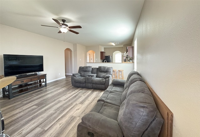 living room with hardwood / wood-style flooring and ceiling fan