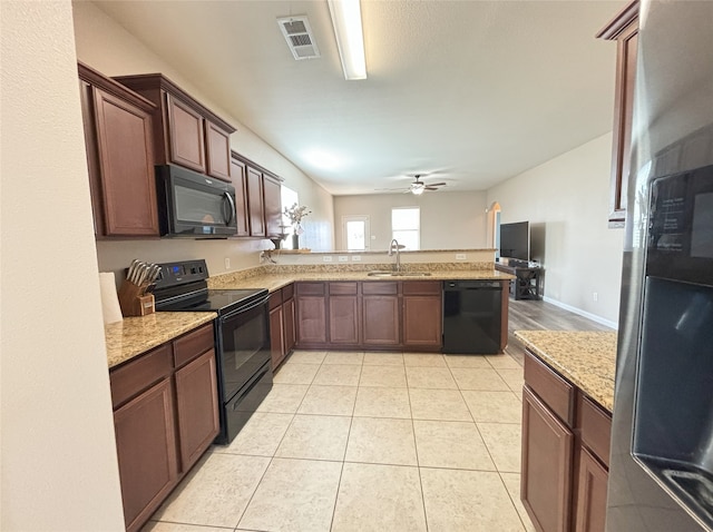 kitchen featuring sink, light tile patterned floors, kitchen peninsula, and black appliances