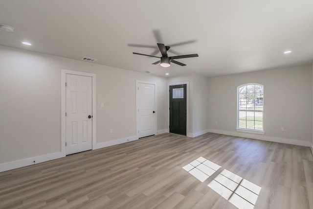 empty room featuring light hardwood / wood-style flooring and ceiling fan