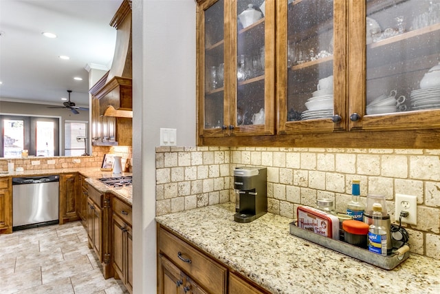 kitchen with light stone counters, brown cabinets, crown molding, decorative backsplash, and dishwasher