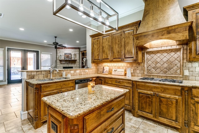 kitchen featuring ceiling fan, a sink, appliances with stainless steel finishes, backsplash, and custom exhaust hood