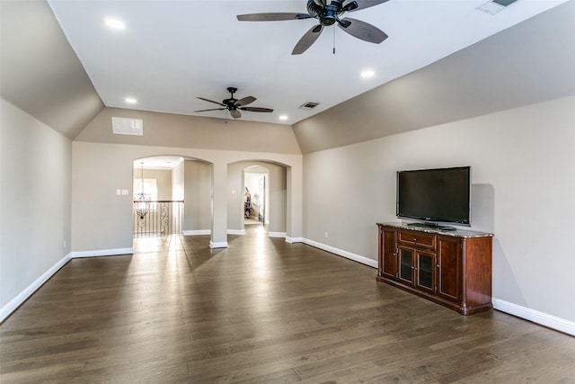 unfurnished living room featuring baseboards, visible vents, arched walkways, lofted ceiling, and dark wood-style flooring