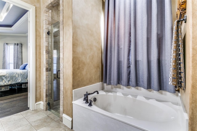 ensuite bathroom with ensuite bathroom, a stall shower, a garden tub, and tile patterned floors