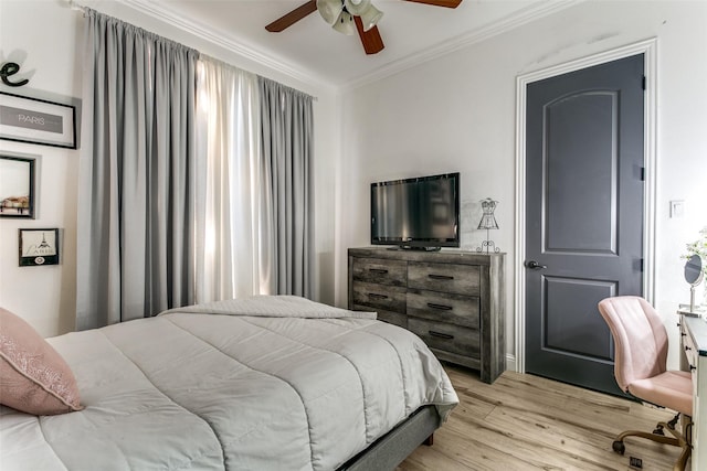 bedroom featuring a ceiling fan, ornamental molding, and wood finished floors