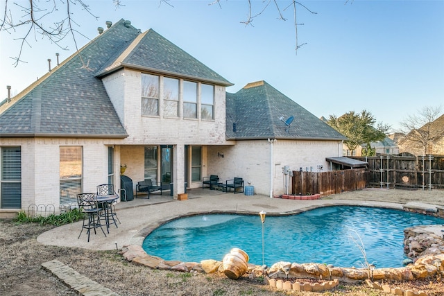 view of pool featuring a patio area, fence, and a fenced in pool