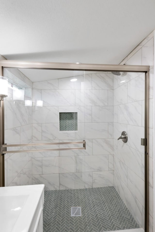 bathroom with a shower with shower door