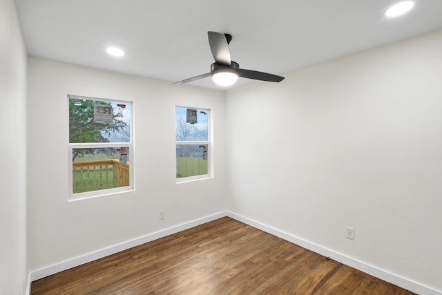 empty room with ceiling fan and wood-type flooring