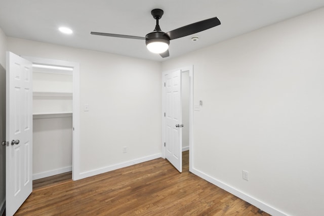 unfurnished bedroom with ceiling fan, dark hardwood / wood-style flooring, and a closet