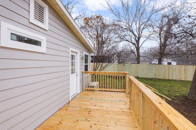 wooden deck featuring a yard