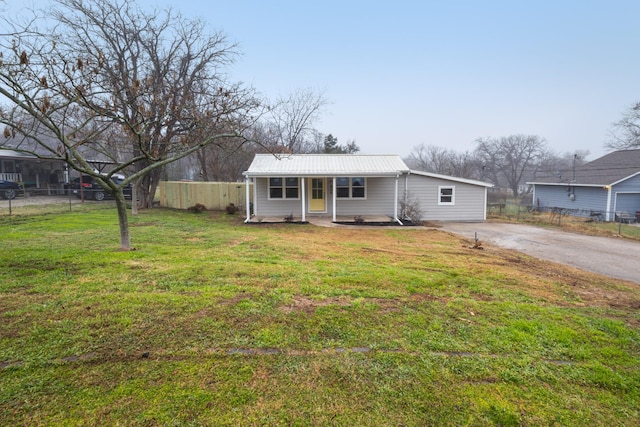 ranch-style home with covered porch and a front yard