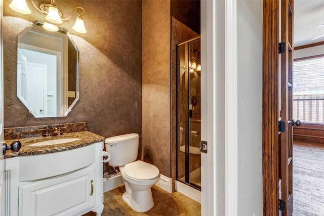 bathroom featuring vanity, toilet, and an enclosed shower