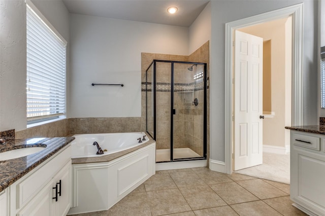 bathroom with tile patterned flooring, vanity, and separate shower and tub