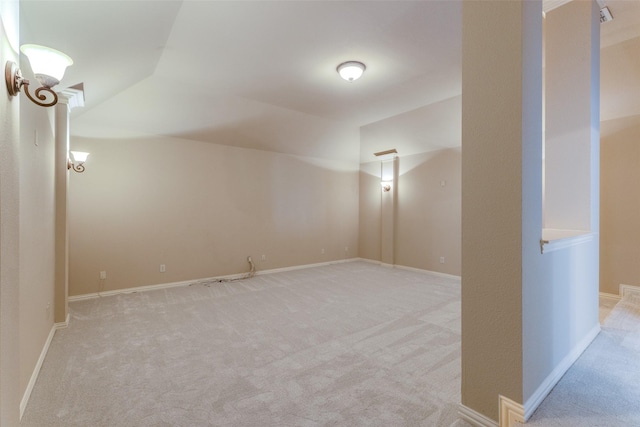 bonus room featuring lofted ceiling and light colored carpet