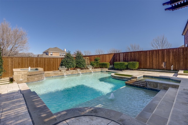 view of pool with an in ground hot tub and pool water feature