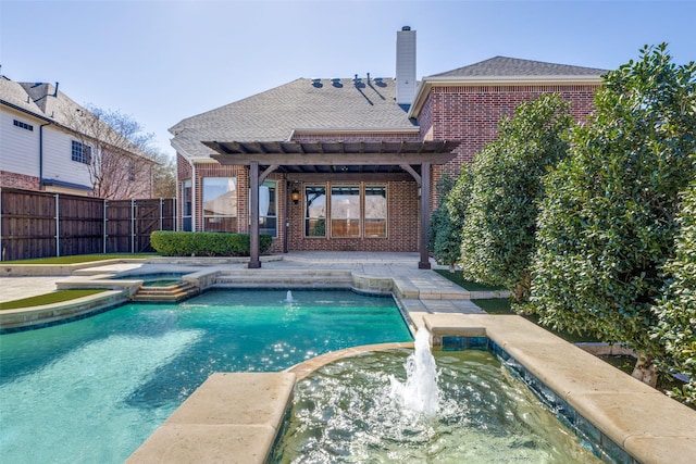 view of swimming pool featuring pool water feature and an in ground hot tub