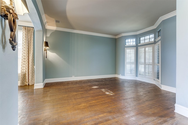 unfurnished room featuring ornamental molding and dark hardwood / wood-style flooring