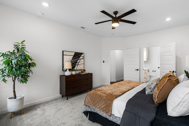 carpeted bedroom featuring ceiling fan and ensuite bath