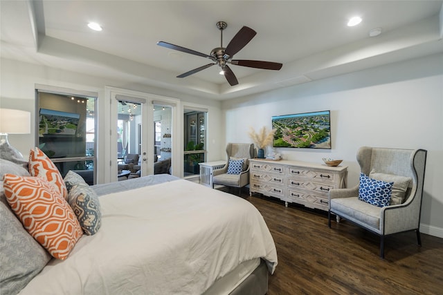 bedroom featuring a raised ceiling, ceiling fan, access to outside, and dark hardwood / wood-style flooring