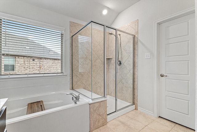 bathroom with plus walk in shower, lofted ceiling, and vanity