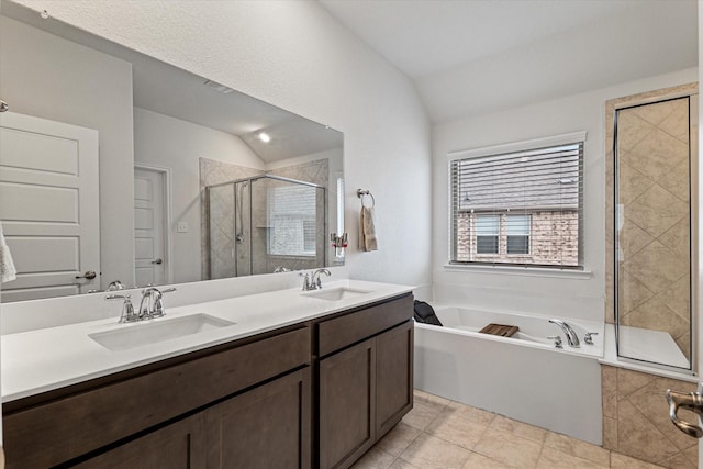 bathroom with shower with separate bathtub, lofted ceiling, and vanity