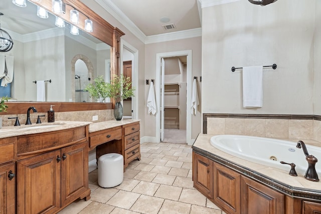 bathroom featuring vanity, crown molding, tile patterned floors, and a tub