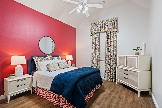 bedroom featuring dark hardwood / wood-style flooring, vaulted ceiling, and ceiling fan