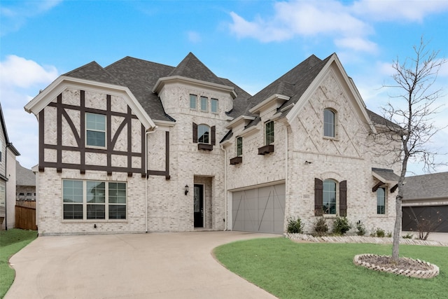 french country home with a garage and a front yard