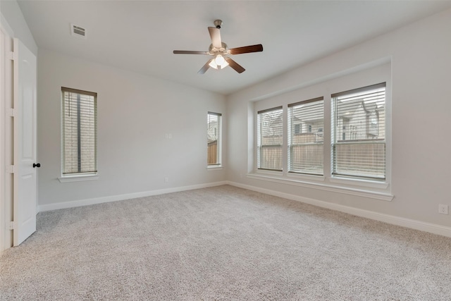 carpeted spare room with ceiling fan