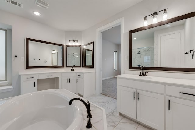 bathroom with vanity and independent shower and bath