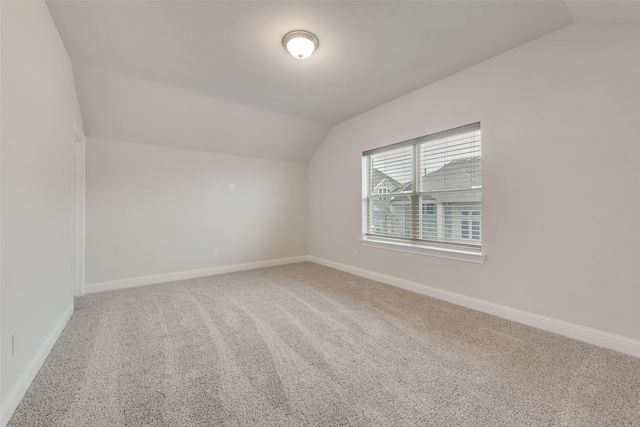 bonus room featuring vaulted ceiling and carpet