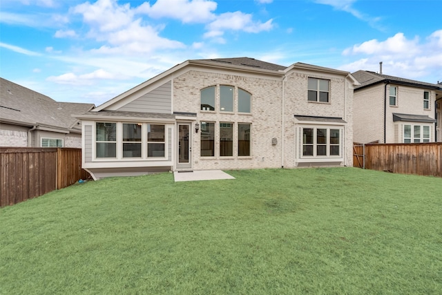 rear view of house with a lawn