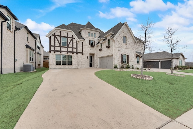 view of front of home with central AC unit, a garage, and a front yard