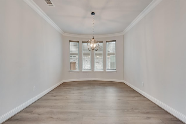 unfurnished dining area featuring an inviting chandelier, crown molding, and light hardwood / wood-style flooring