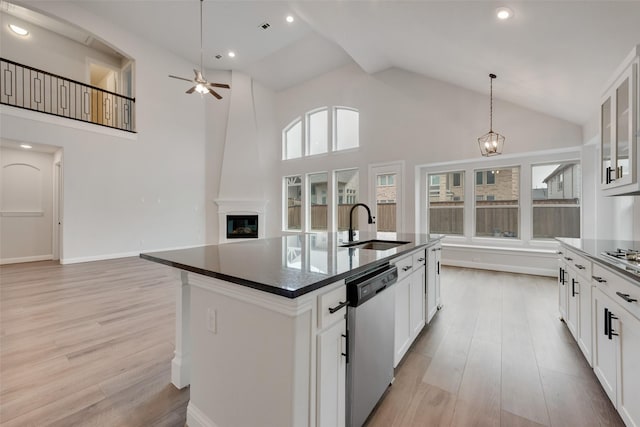 kitchen featuring white cabinetry, sink, dishwasher, and a kitchen island with sink