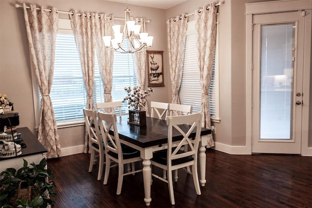 dining room featuring baseboards, dark wood-style floors, and a chandelier