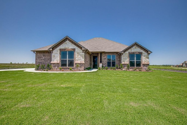 view of front of house featuring a front yard and stone siding