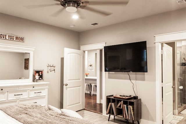 bedroom featuring light wood-style floors, ceiling fan, and visible vents