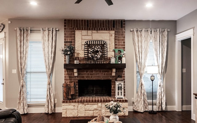 living room featuring baseboards, ceiling fan, wood finished floors, and a fireplace