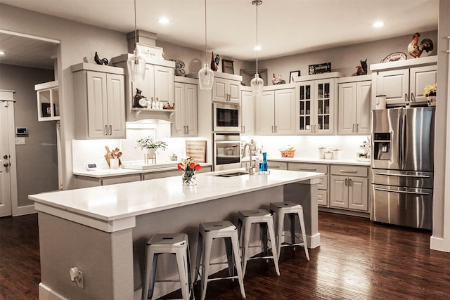 kitchen with recessed lighting, dark wood-style floors, and stainless steel appliances
