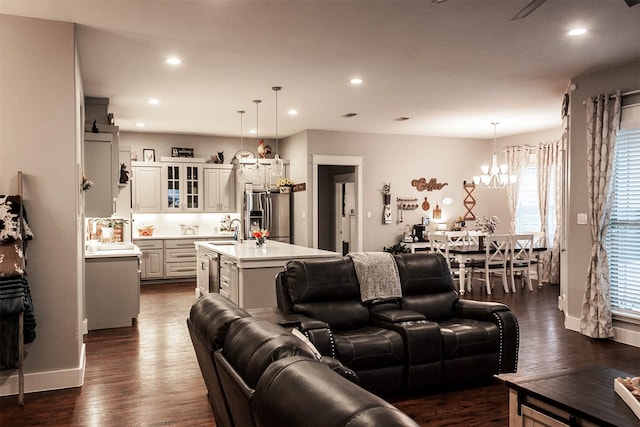 living room with recessed lighting, baseboards, dark wood finished floors, and a chandelier