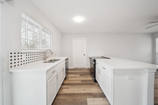 kitchen featuring sink, white cabinetry, light wood-type flooring, dishwasher, and electric stove