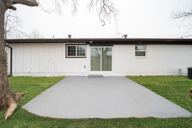 rear view of property with a lawn and a patio area