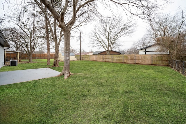 view of yard featuring central AC unit and a patio area