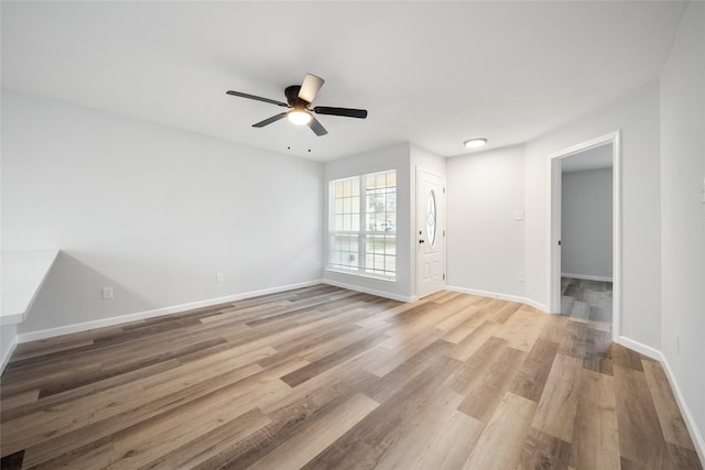 empty room featuring ceiling fan and light hardwood / wood-style floors