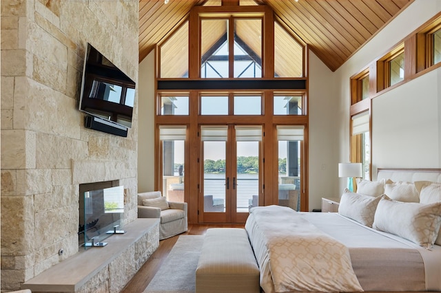 bedroom featuring wood-type flooring, wooden ceiling, access to exterior, and high vaulted ceiling