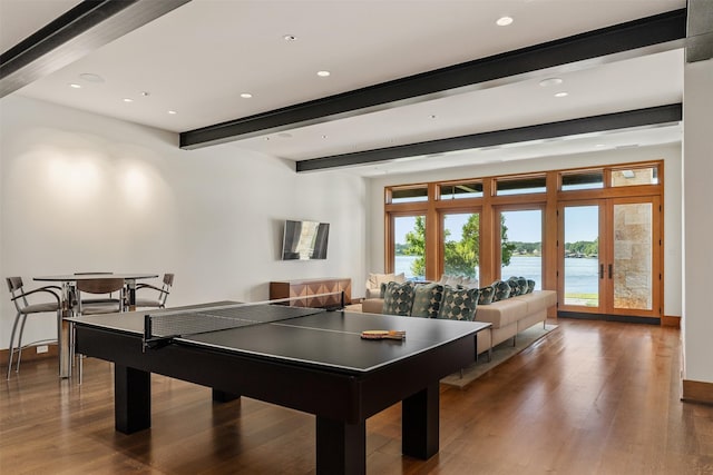 game room with beamed ceiling, dark hardwood / wood-style flooring, and french doors