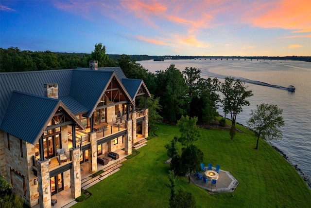 aerial view at dusk with a water view