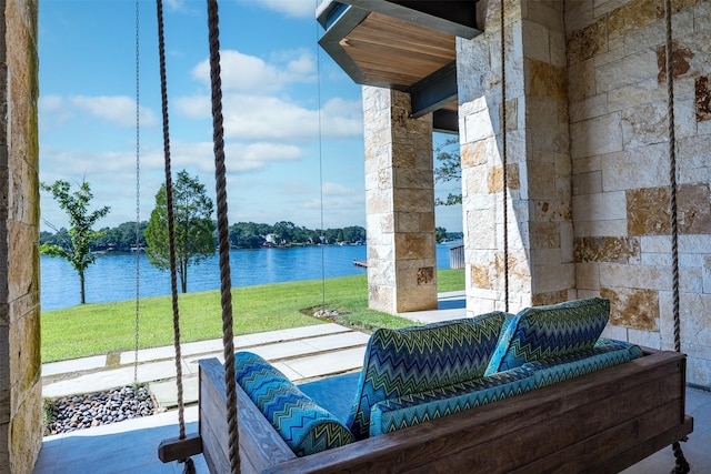 exterior space with a water view and an outdoor living space